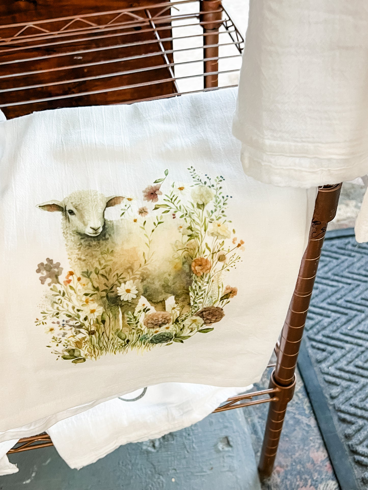 Lamb in wildflower field Kitchen Towel